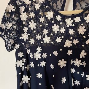 Navy blue maternity dress with 3-D flowers.